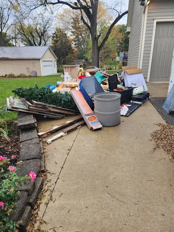 Dumpster being loaded with debris for Estate Cleanout Dumpster Rental in Belleview
